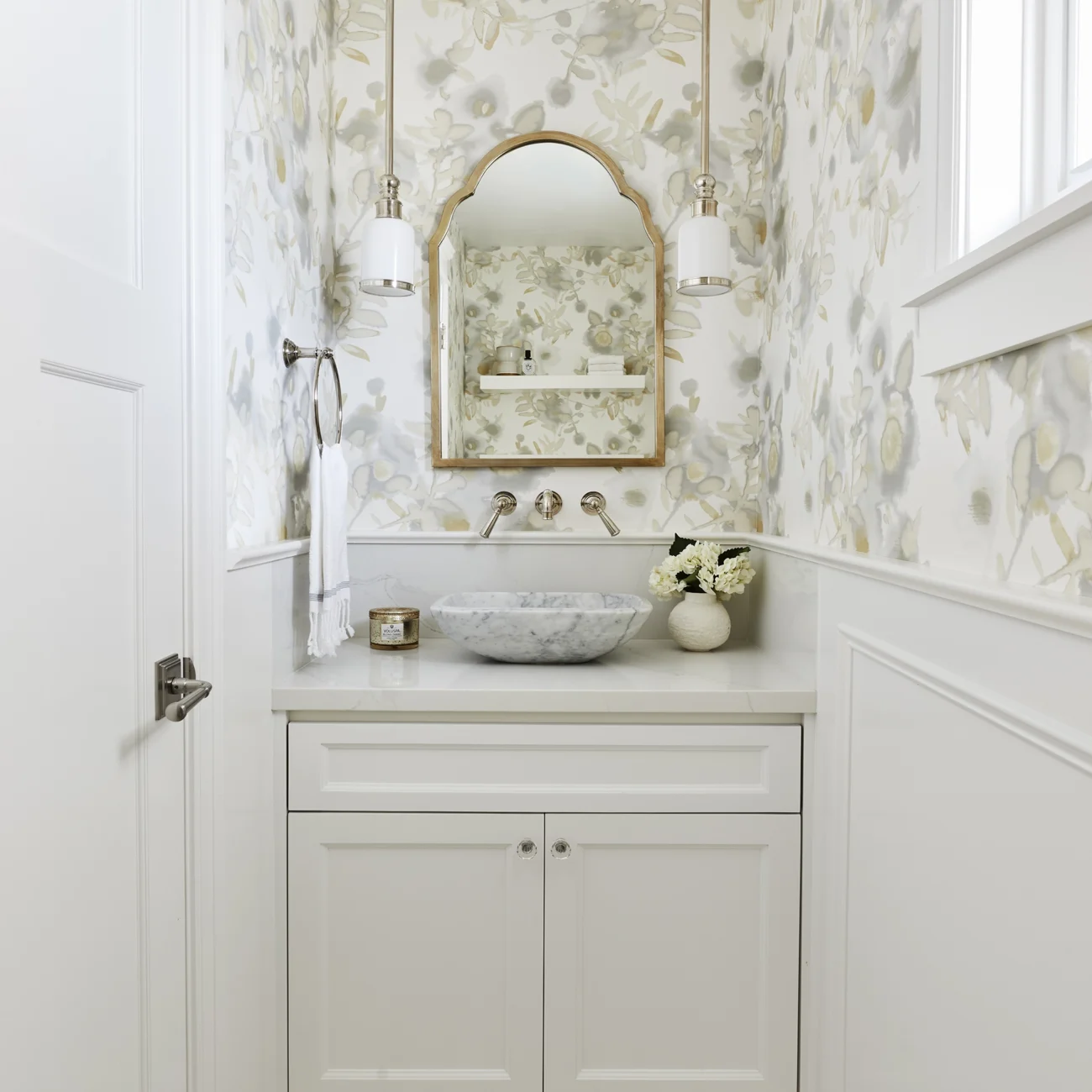 Christine Vroom Interiors Vigilance | Bright white marble powder room with marble mounted sink