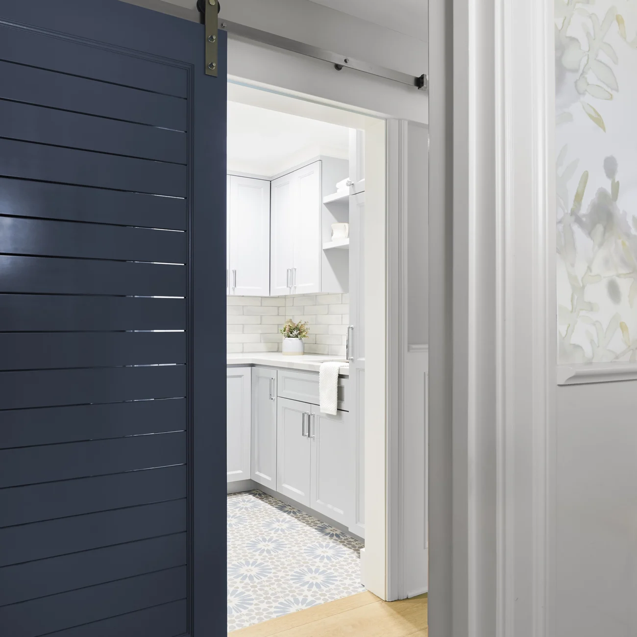 Christine Vroom Interiors Vigilance | Blue slatted barn door to conceal laundry room