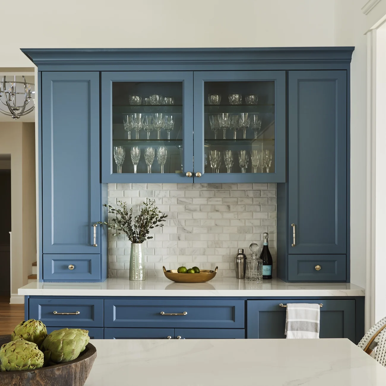 Christine Vroom Interiors Vigilance | Kitchen with hardwood floors and blue cabinet built-in