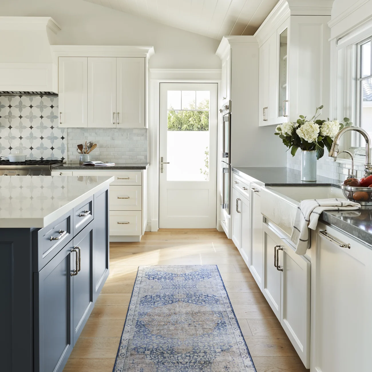 Christine Vroom Interiors Vigilance | Kitchen with hardwood with white and blue accent cabinets