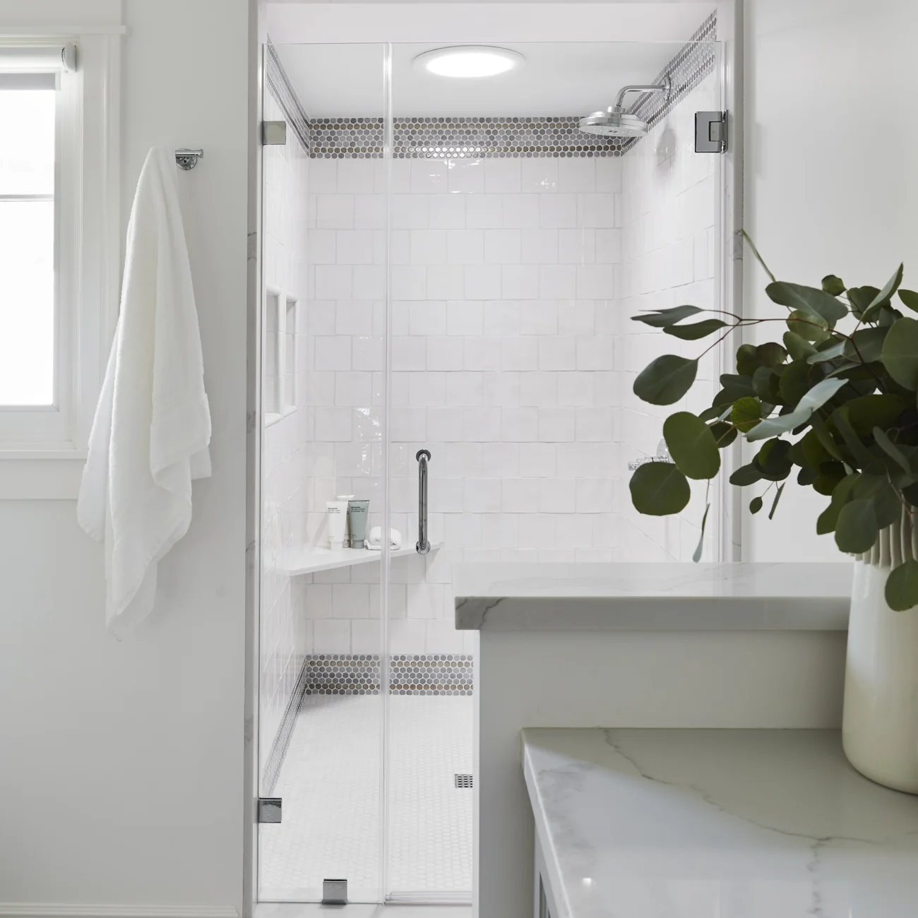 Christine Vroom Interiors Vigilance | Bright white marble bathroom vanity