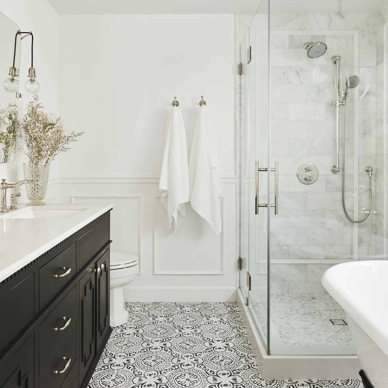 Christine Vroom Interiors | Gentry | Bright, white bathroom with soaker tub and black vanity