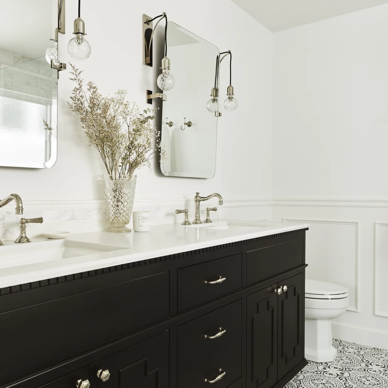 Christine Vroom Interiors | Gentry | Bright, white bathroom with soaker tub and balck vanity