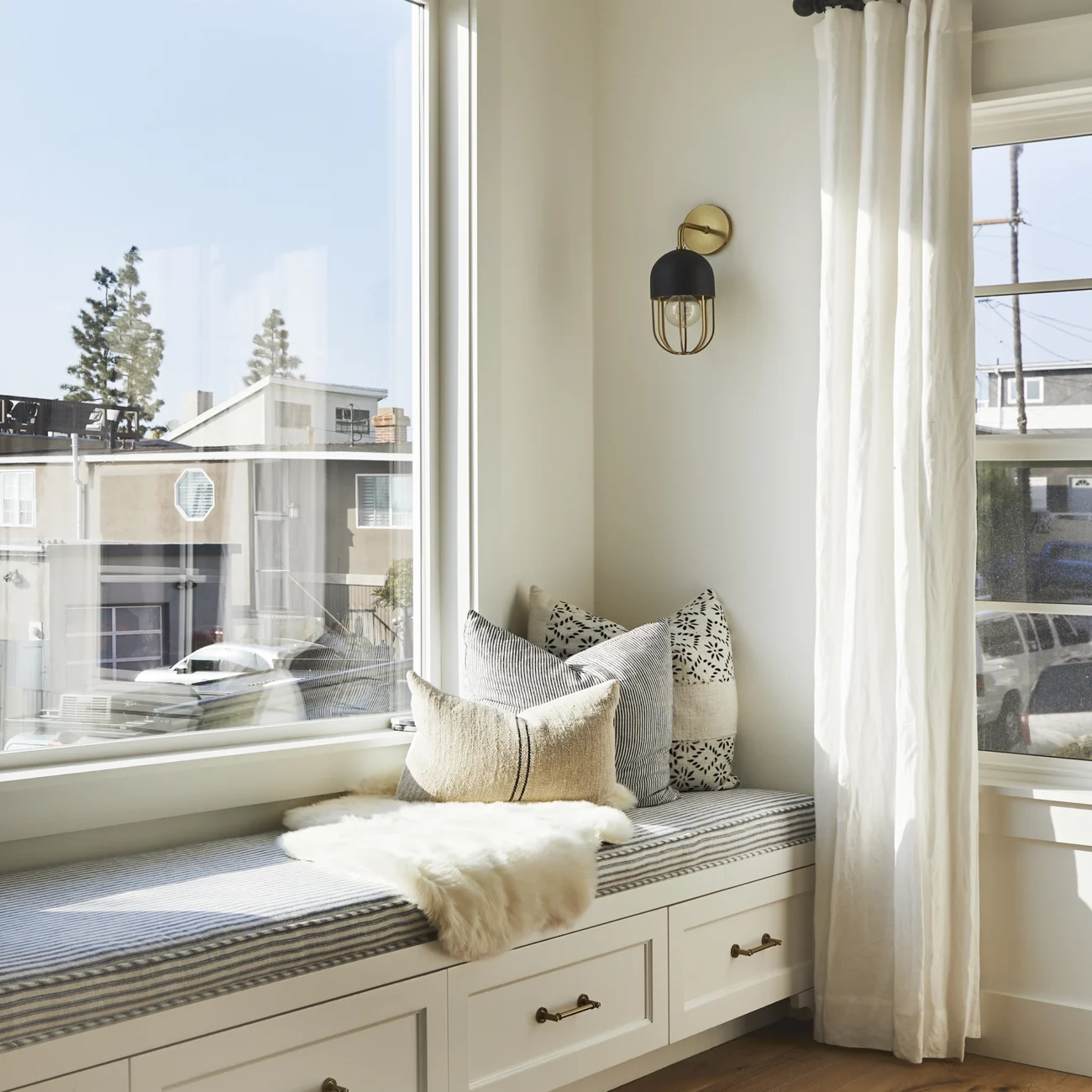Christine Vroom Interiors | Gentry | Bright, white living room with window seat storage