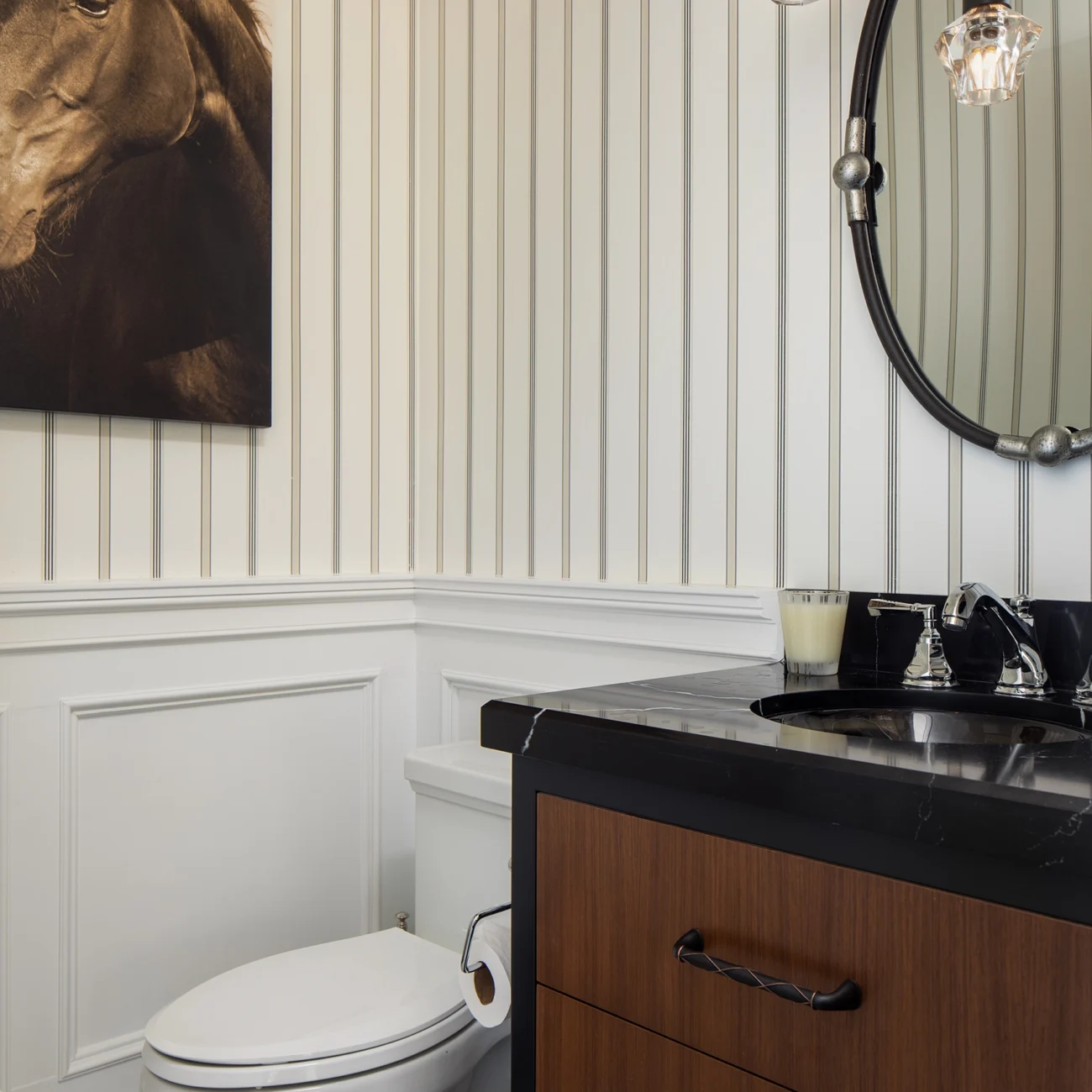 Christine Vroom Interiors Strawberry Lane | Traditional equestrian themed bathroom with black sink and wainscoting