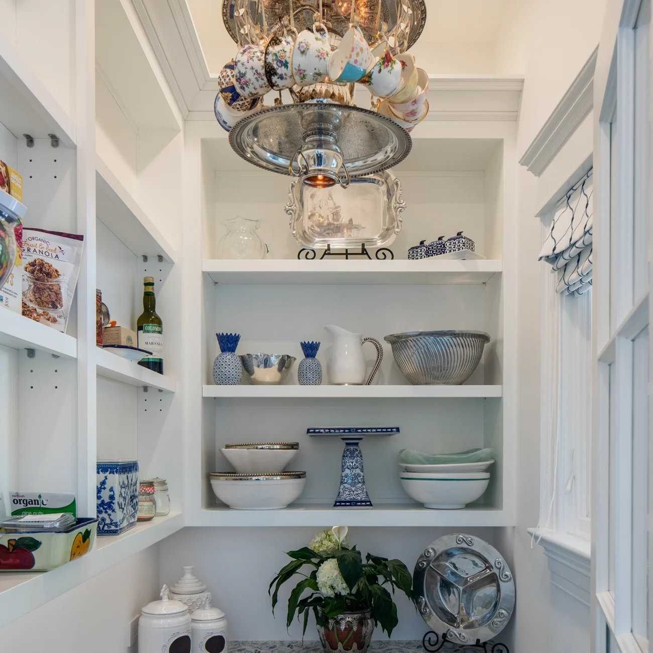 Christine Vroom Interiors Strawberry Lane | Traditional pantry with whimsical custom teacup and silver platter chandelier