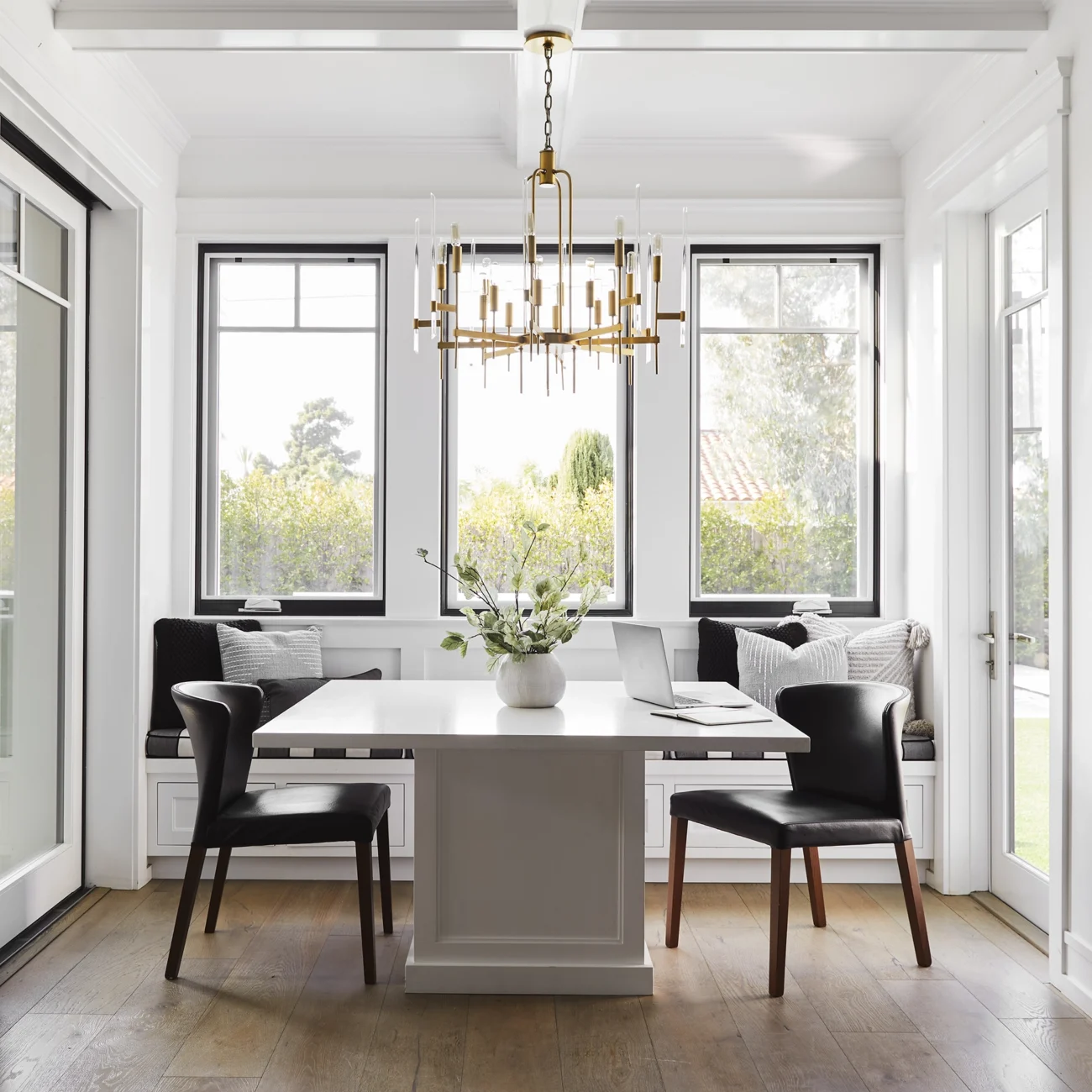Christine Vroom-Interiors Thayer | Traditional white kitchen dining nook with gold chandelier