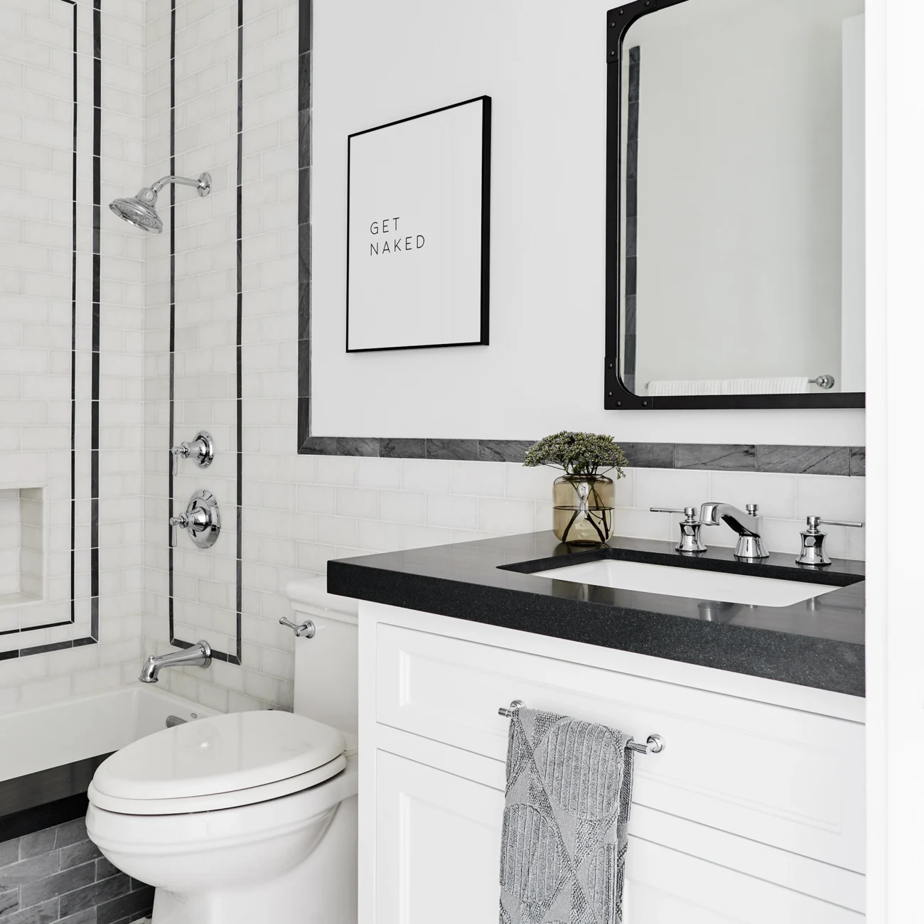 Christine Vroom-Interiors Thayer | Traditional bathroom tiled bathroom with white and black tile and black counter top