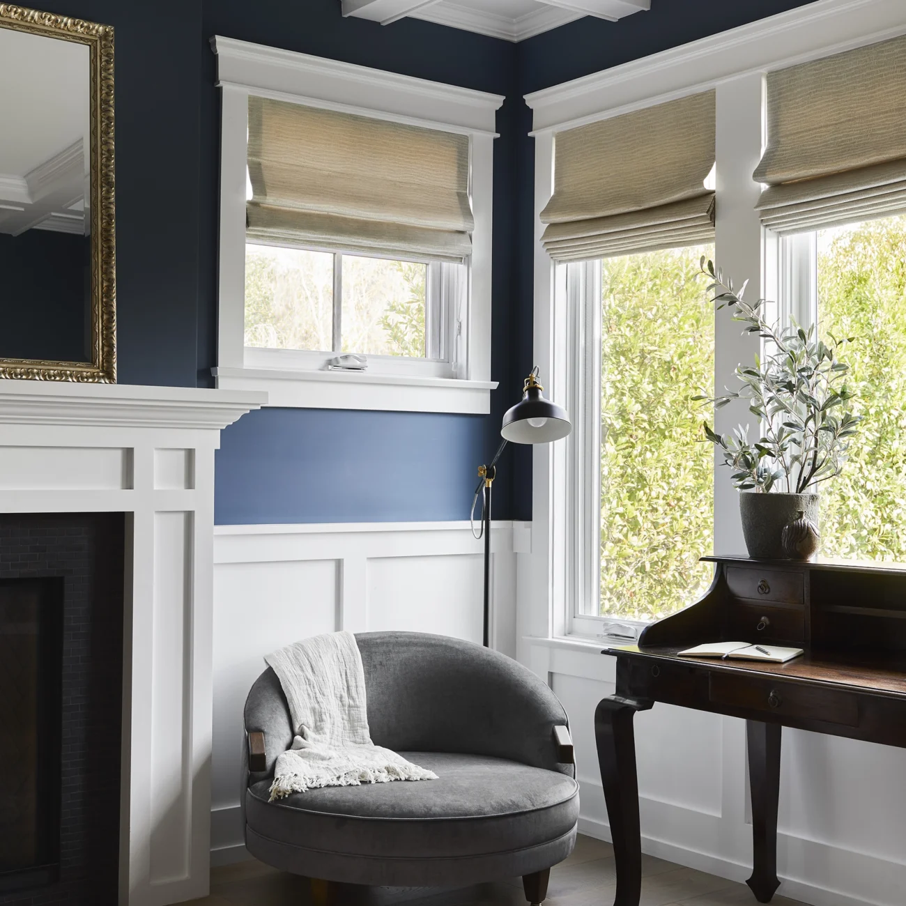Christine Vroom-Interiors Thayer | Traditional living room with blue walls and white trim with crown moulding