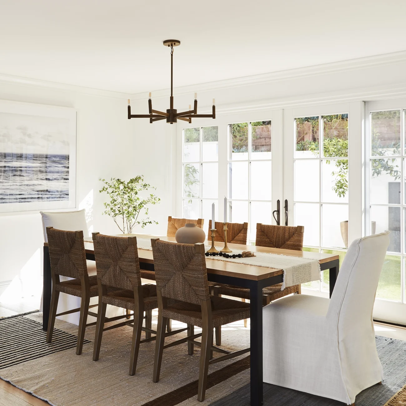 Christine Vroom Interiors | Via Almar | Costal dining room with floor to ceiling windows and doors