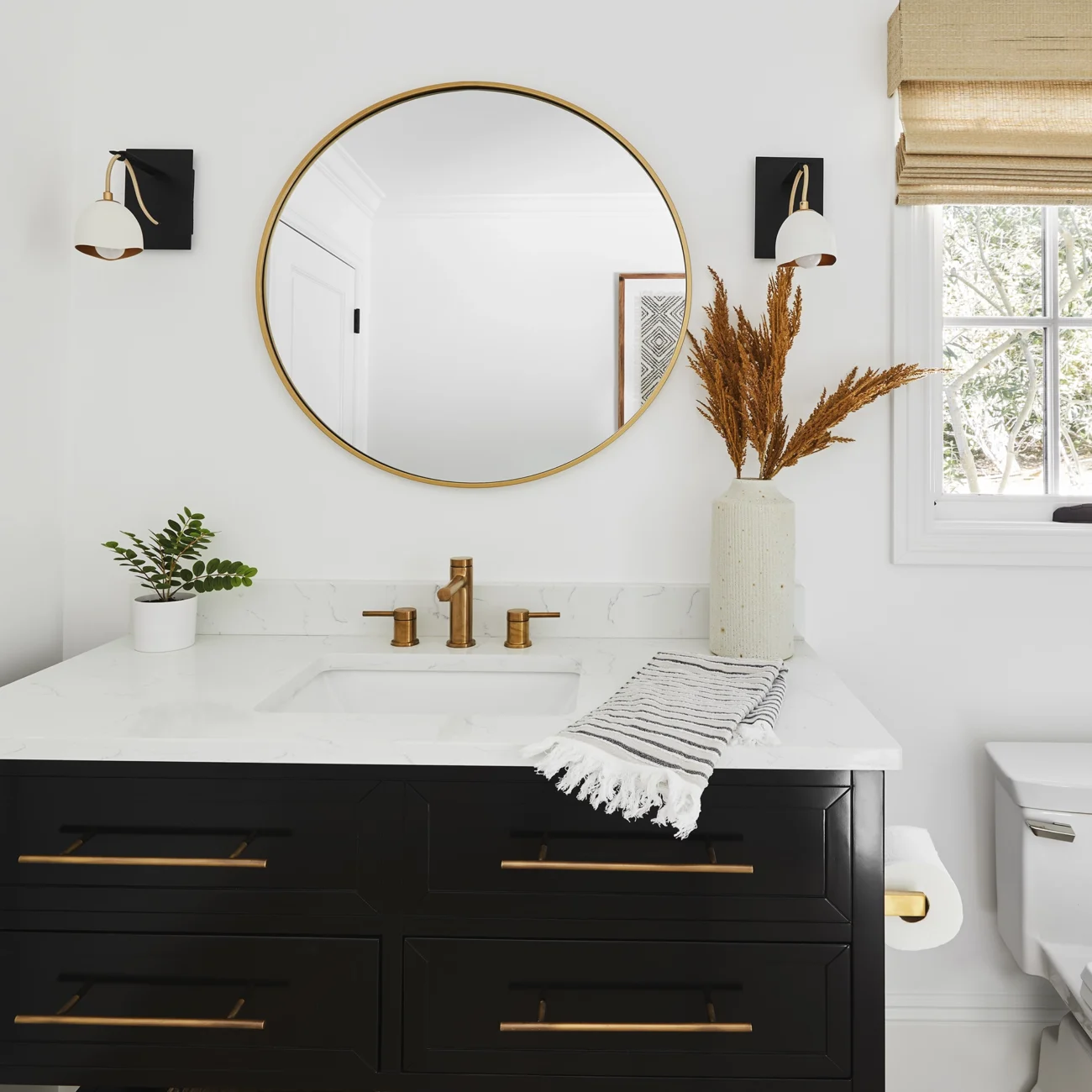Christine Vroom Interiors | Via Almar | Costal bathroom with gold accents and black vanity