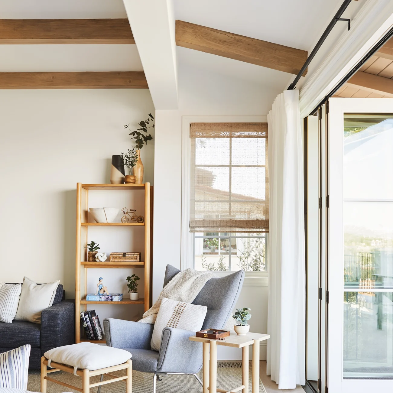 Christine Vroom Interiors | Via Almar | Costal Bright living room with floor to ceiling windows and doors and exposed beams