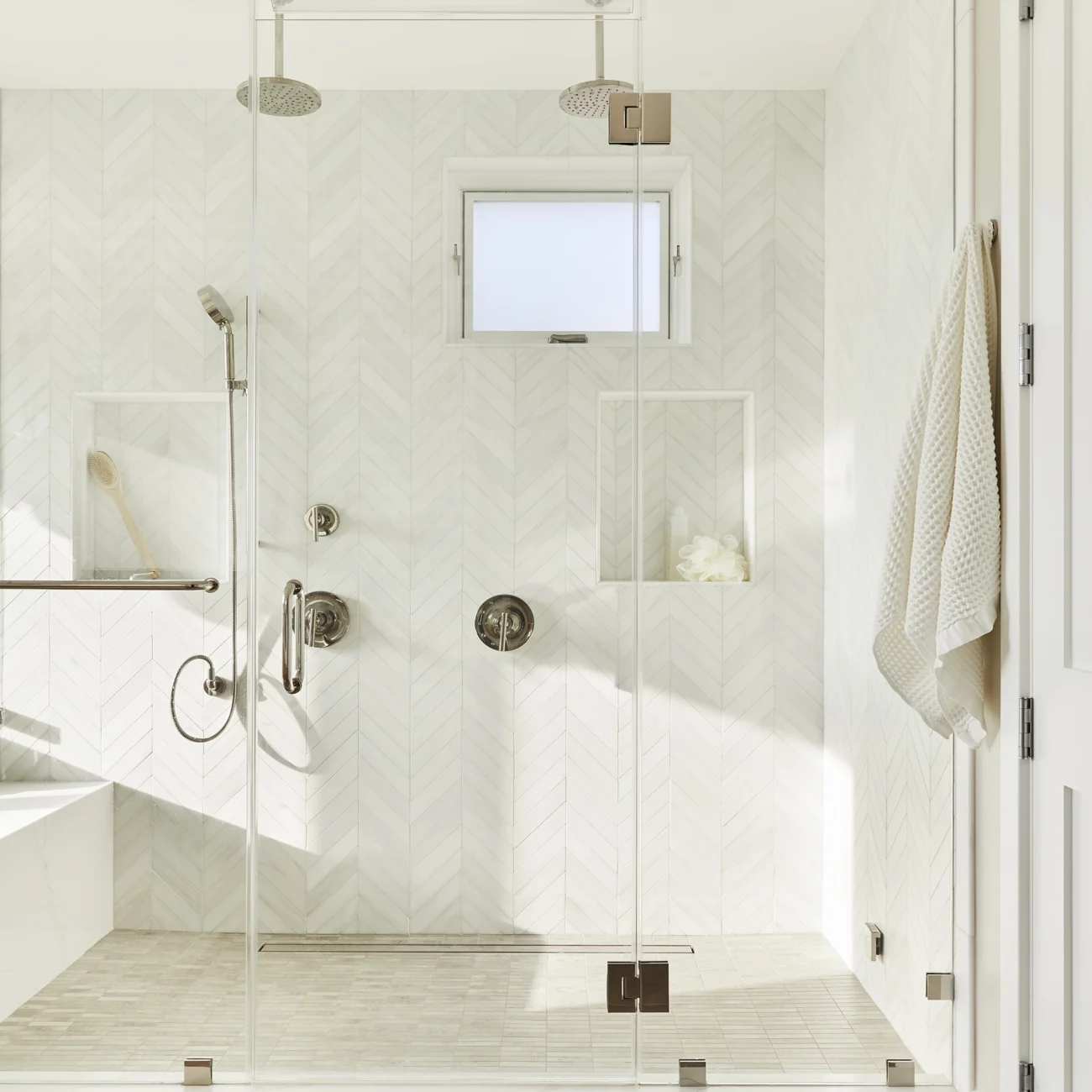 Christine Vroom Interiors | 27th | bright, costal bathroom with herringbone patterned tile