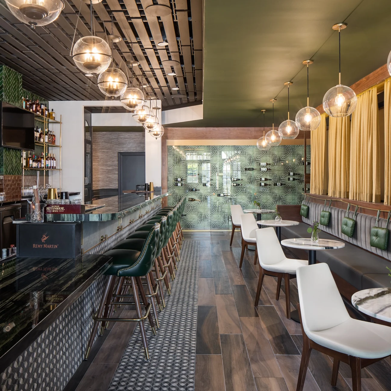 Christine Vroom Interiors Pacific Standard | Contemporary Restaurant Interior with plants, green print wallpaper, green tile, gold and black accents and wood floors
