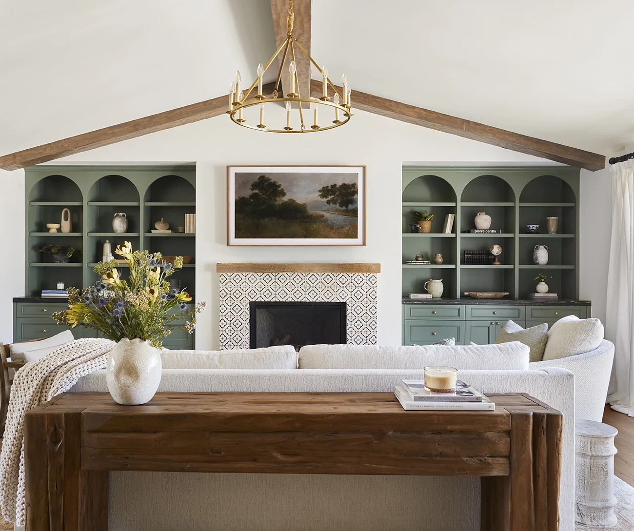 Custom forest green cabinets in a spanish style home in los angeles, california. Arched Cabinets in a living room. Mosaic fireplace